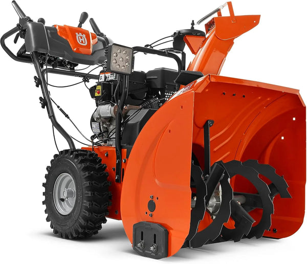 Orange and black snowblower on a white background